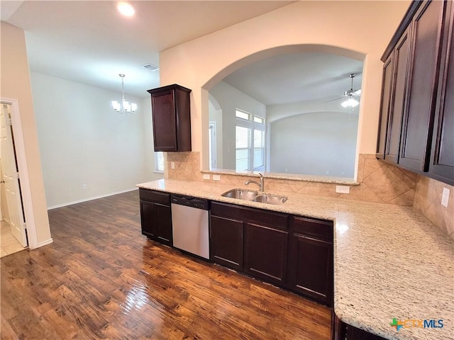 kitchen featuring tasteful backsplash, visible vents, dark wood finished floors, dishwasher, and a sink