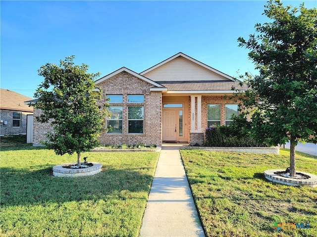 view of front of house with a front lawn and brick siding