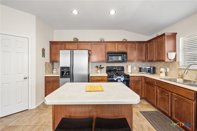 kitchen featuring a sink, lofted ceiling, black appliances, and light tile patterned flooring