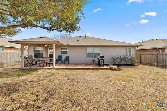 back of property featuring a fenced backyard, ceiling fan, and a patio