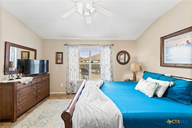 bedroom with baseboards, a ceiling fan, and vaulted ceiling