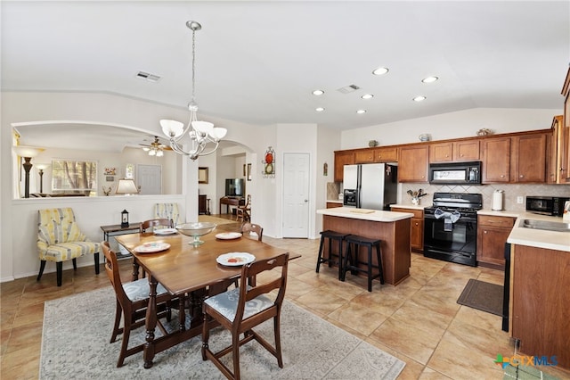 dining room featuring recessed lighting, visible vents, arched walkways, and vaulted ceiling