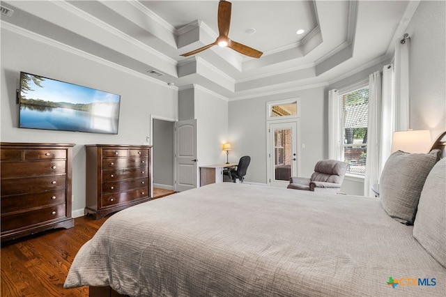 bedroom featuring dark wood-type flooring, ceiling fan, a raised ceiling, and crown molding