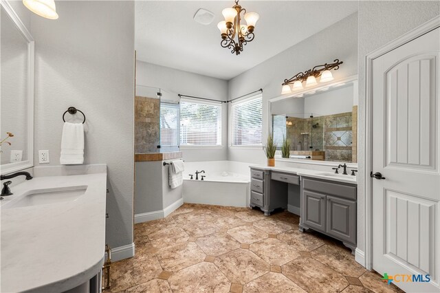 bathroom with vanity, a chandelier, and plus walk in shower