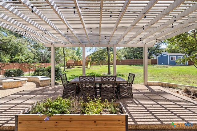 view of patio with a pergola and a storage unit