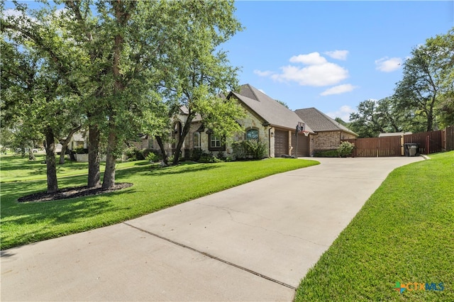 view of front of home with a garage and a front lawn