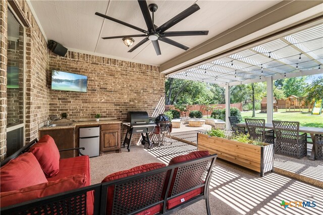 view of patio / terrace with a pergola, an outdoor kitchen, outdoor lounge area, a grill, and ceiling fan