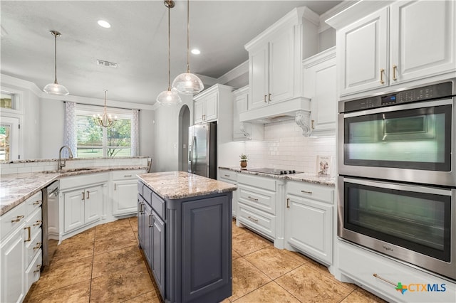 kitchen with white cabinetry, stainless steel appliances, a center island, and pendant lighting