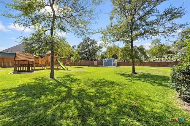 view of yard featuring a playground and a storage unit