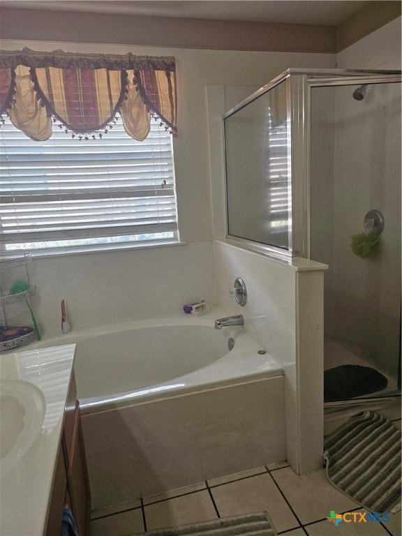 bathroom with plus walk in shower, vanity, and tile patterned flooring