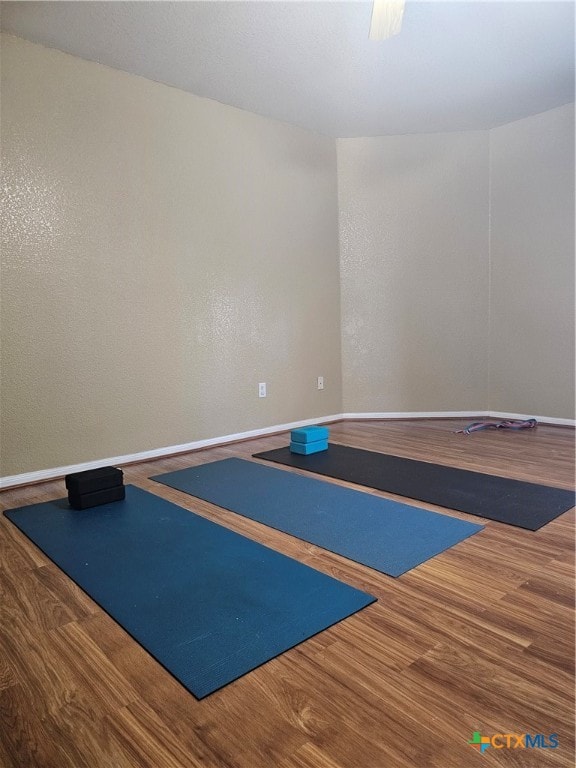 workout room with wood-type flooring and basketball court