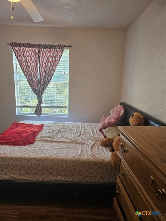 bedroom with ceiling fan and hardwood / wood-style floors