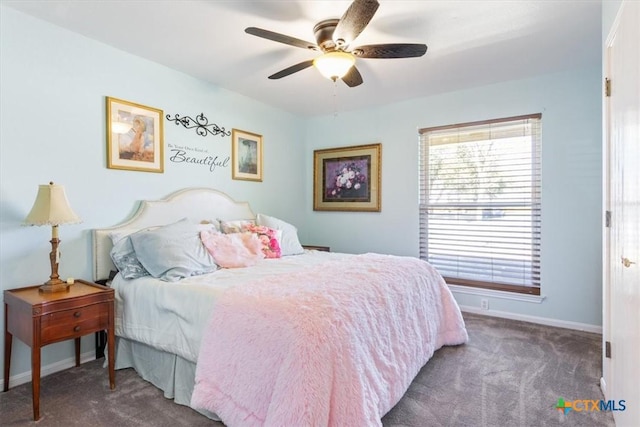 carpeted bedroom with baseboards and a ceiling fan