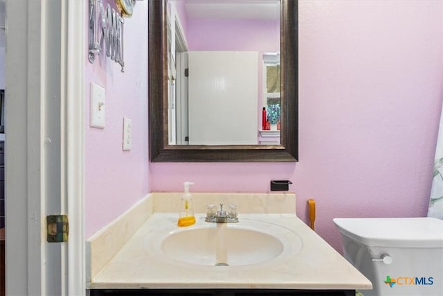 half bathroom featuring toilet and vanity