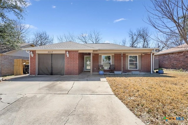 ranch-style house featuring a garage, brick siding, fence, concrete driveway, and roof with shingles