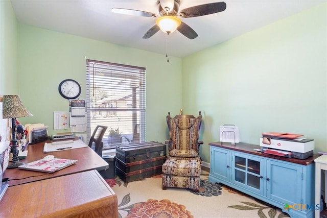 carpeted office space featuring ceiling fan