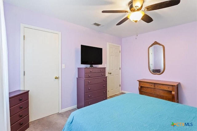 bedroom with baseboards, carpet flooring, visible vents, and a ceiling fan