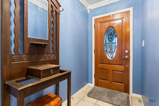 entrance foyer featuring baseboards, light tile patterned flooring, and crown molding