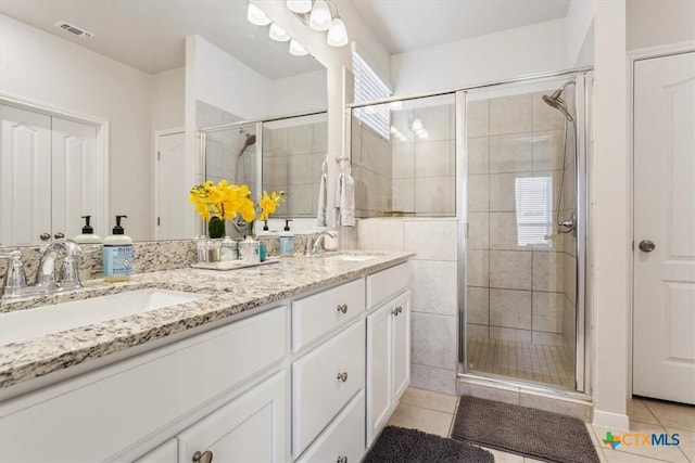 3703 Mccleland Creek Trl, Temple, TX 76502 - bathroom featuring tile patterned floors, a shower stall, and double vanity