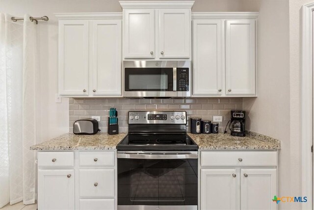 3703 Mccleland Creek Trl, Temple, TX 76502 - kitchen featuring stainless steel appliances, tasteful backsplash, white cabinetry, and light stone counters