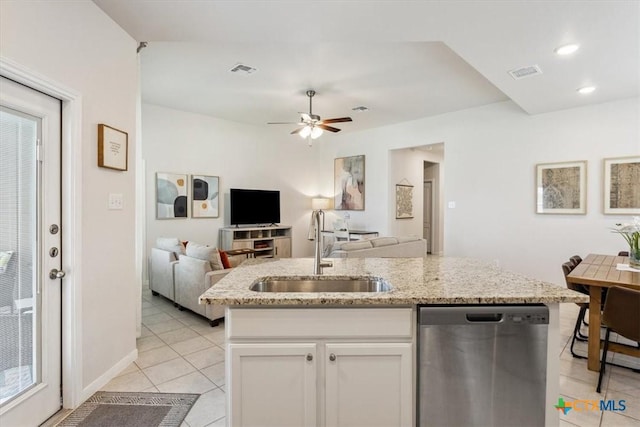 3703 Mccleland Creek Trl, Temple, TX 76502 - kitchen featuring stainless steel dishwasher, a sink, light tile patterned floors, white cabinetry, and open floor plan