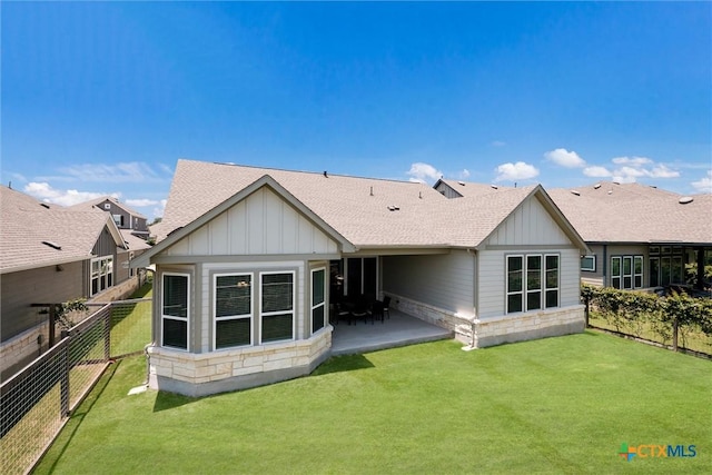 11305 Hollering Pass, Schertz, TX 78154 - rear view of property with board and batten siding, roof with shingles, stone siding, and a fenced backyard