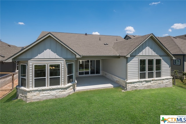 back of house featuring a patio and a lawn