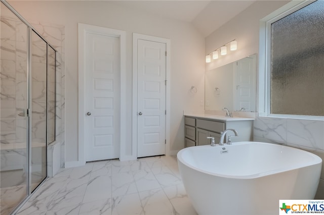 bathroom with independent shower and bath and vanity