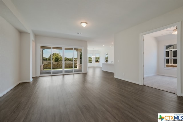 unfurnished living room with ceiling fan and dark hardwood / wood-style floors