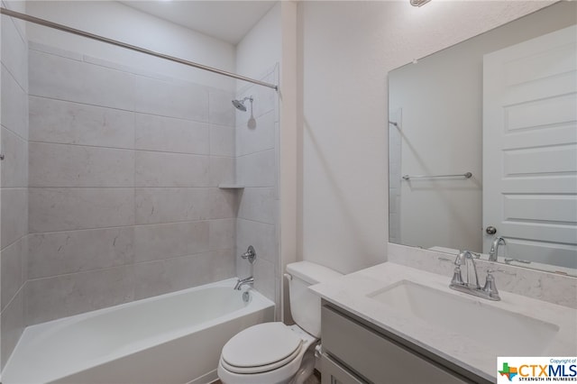 full bathroom with vanity, toilet, and tiled shower / bath