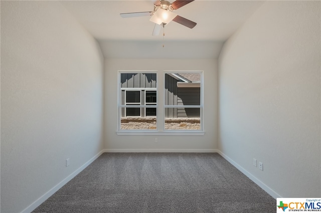 spare room featuring carpet flooring, lofted ceiling, and ceiling fan