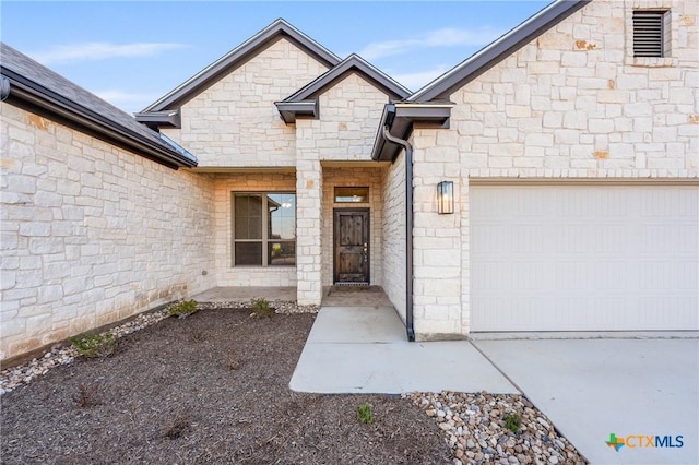 entrance to property featuring an attached garage