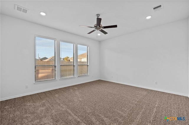 carpeted spare room with recessed lighting, visible vents, and baseboards