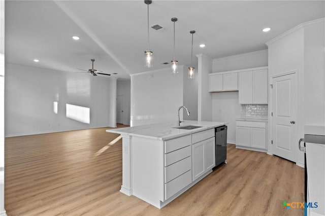 kitchen featuring pendant lighting, black dishwasher, visible vents, white cabinetry, and a sink