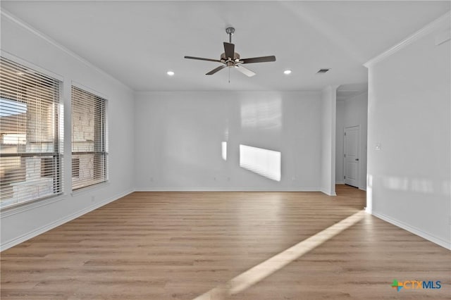 spare room with baseboards, light wood finished floors, recessed lighting, and crown molding