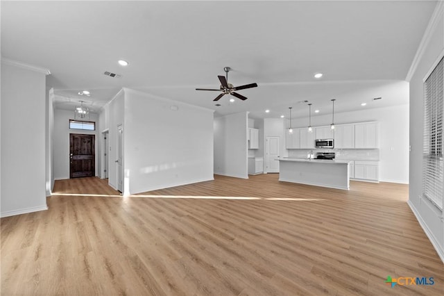 unfurnished living room with visible vents, baseboards, ornamental molding, light wood-type flooring, and ceiling fan with notable chandelier