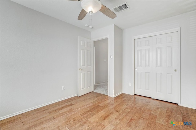 unfurnished bedroom with ceiling fan, light hardwood / wood-style floors, and a closet