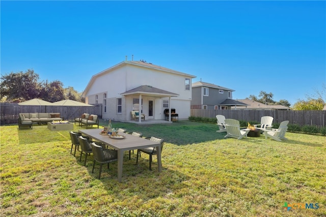 back of property with a yard, a patio area, and outdoor lounge area