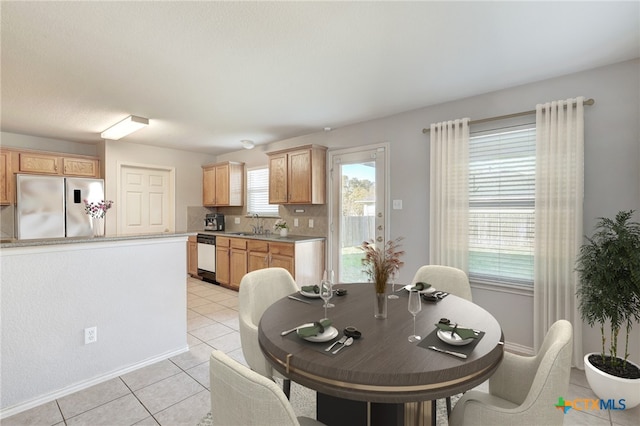 tiled dining room featuring sink