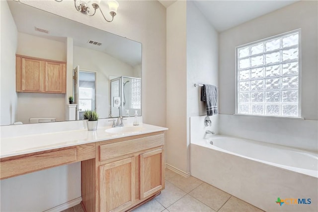 full bathroom with vanity, toilet, tile patterned flooring, and plus walk in shower