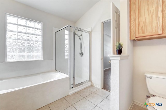 bathroom featuring tile patterned flooring, plus walk in shower, and toilet