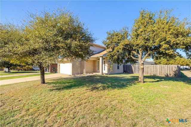 obstructed view of property featuring a front yard and a garage