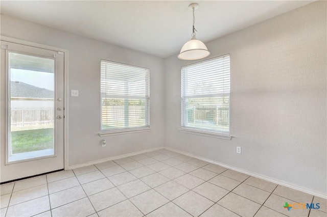 unfurnished dining area with light tile patterned floors