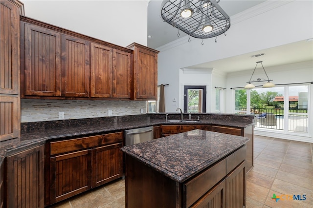 12011 Fm 1150, Luling, TX 78648 - kitchen with stainless steel dishwasher, backsplash, a peninsula, ornamental molding, and dark stone countertops