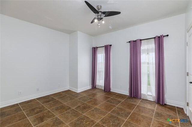 12011 Fm 1150, Luling, TX 78648 - spare room featuring ceiling fan and baseboards