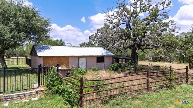 12011 Fm 1150, Luling, TX 78648 - view of side of home with a metal roof and concrete block siding