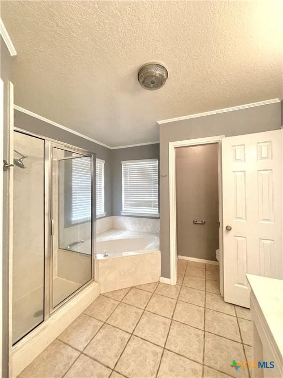 full bathroom with tile patterned flooring, vanity, and a textured ceiling