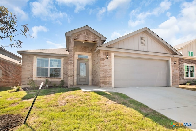 view of front of home featuring a garage and a front yard