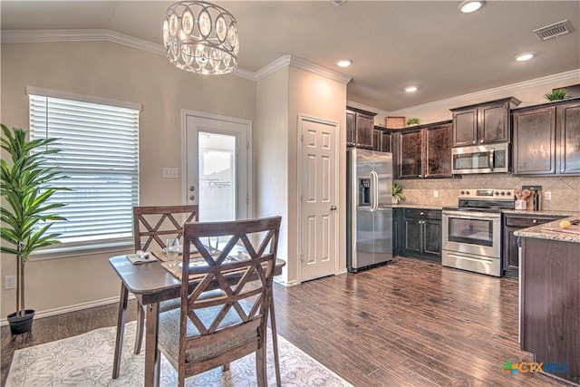 kitchen with appliances with stainless steel finishes, dark wood-style flooring, decorative light fixtures, and dark brown cabinetry