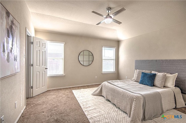 bedroom featuring carpet floors, a ceiling fan, baseboards, and a textured ceiling